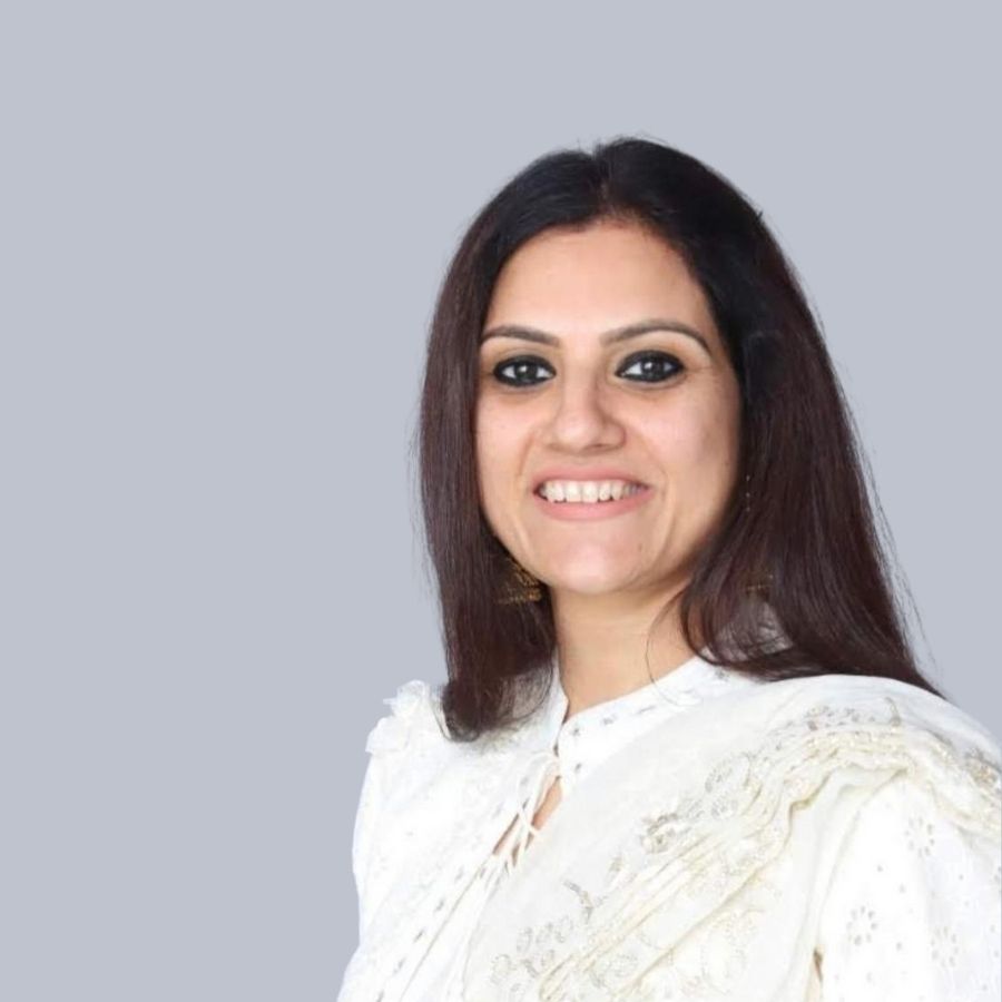 Smiling portrait of Mrs. Deepali Gupta, Founder of The Deep Soil, dressed in a white traditional outfit.